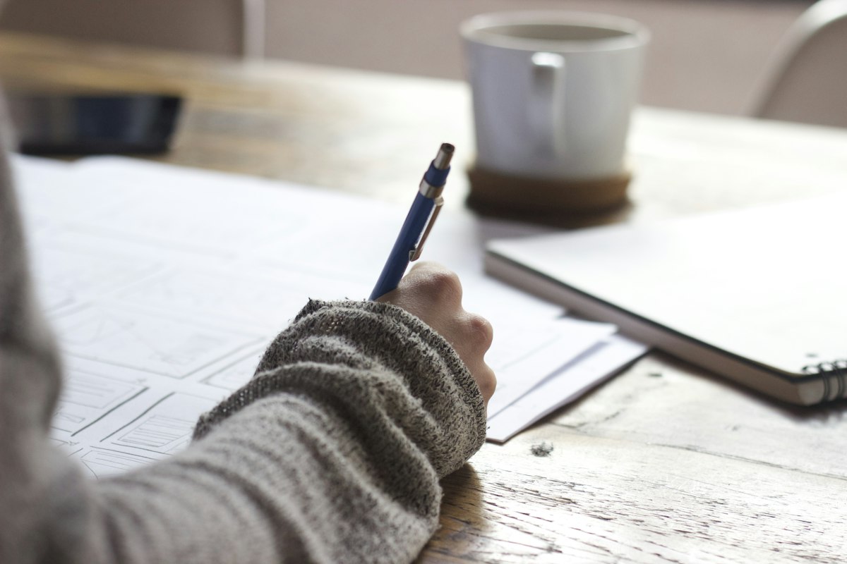 Notebook and calculator beside a laptop during planning